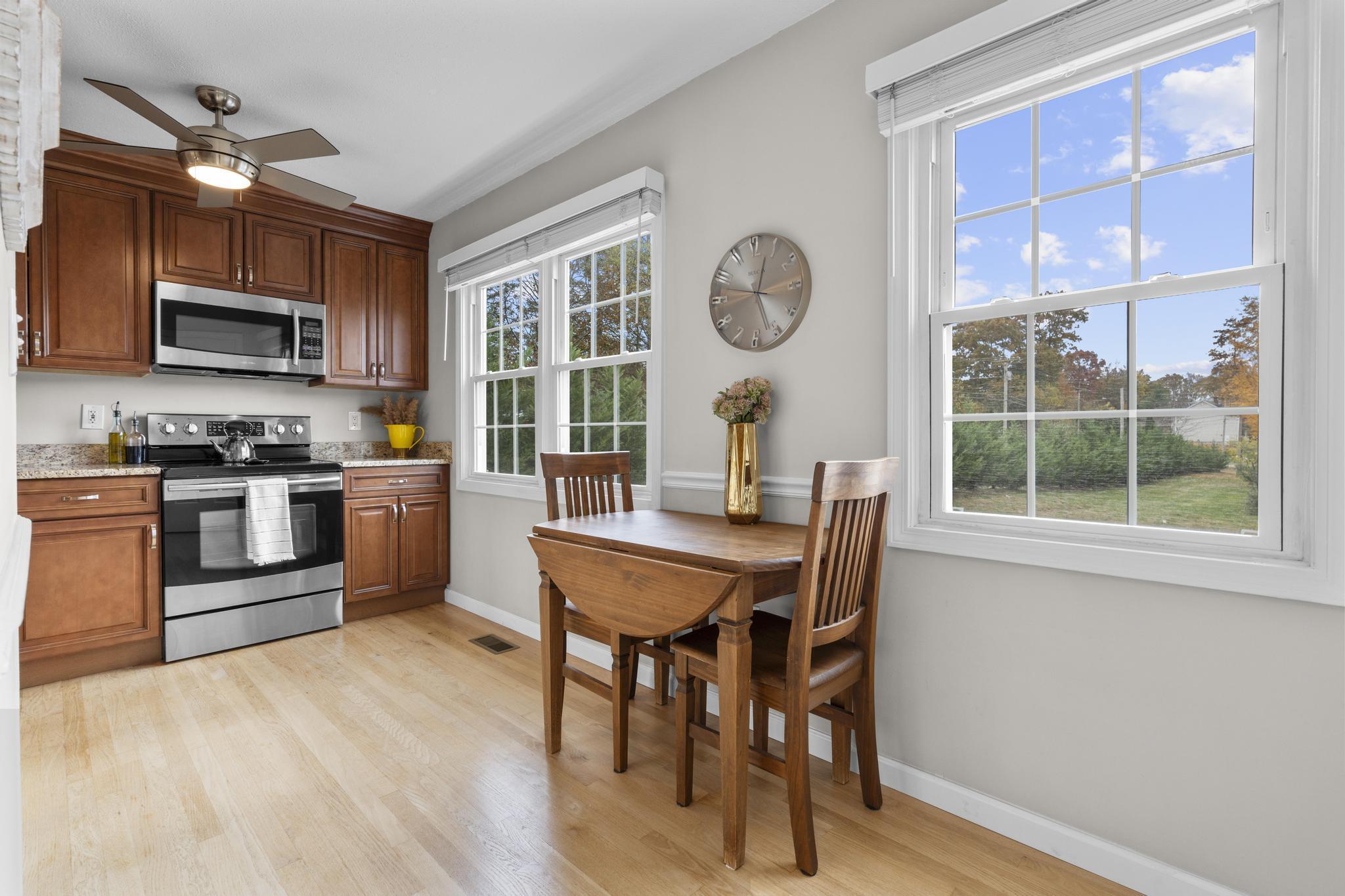 26 Summit Street, Unit 26 Derby, CT 06418 - Photo 21 of 35 a view of a dining room with furniture window and wooden floor