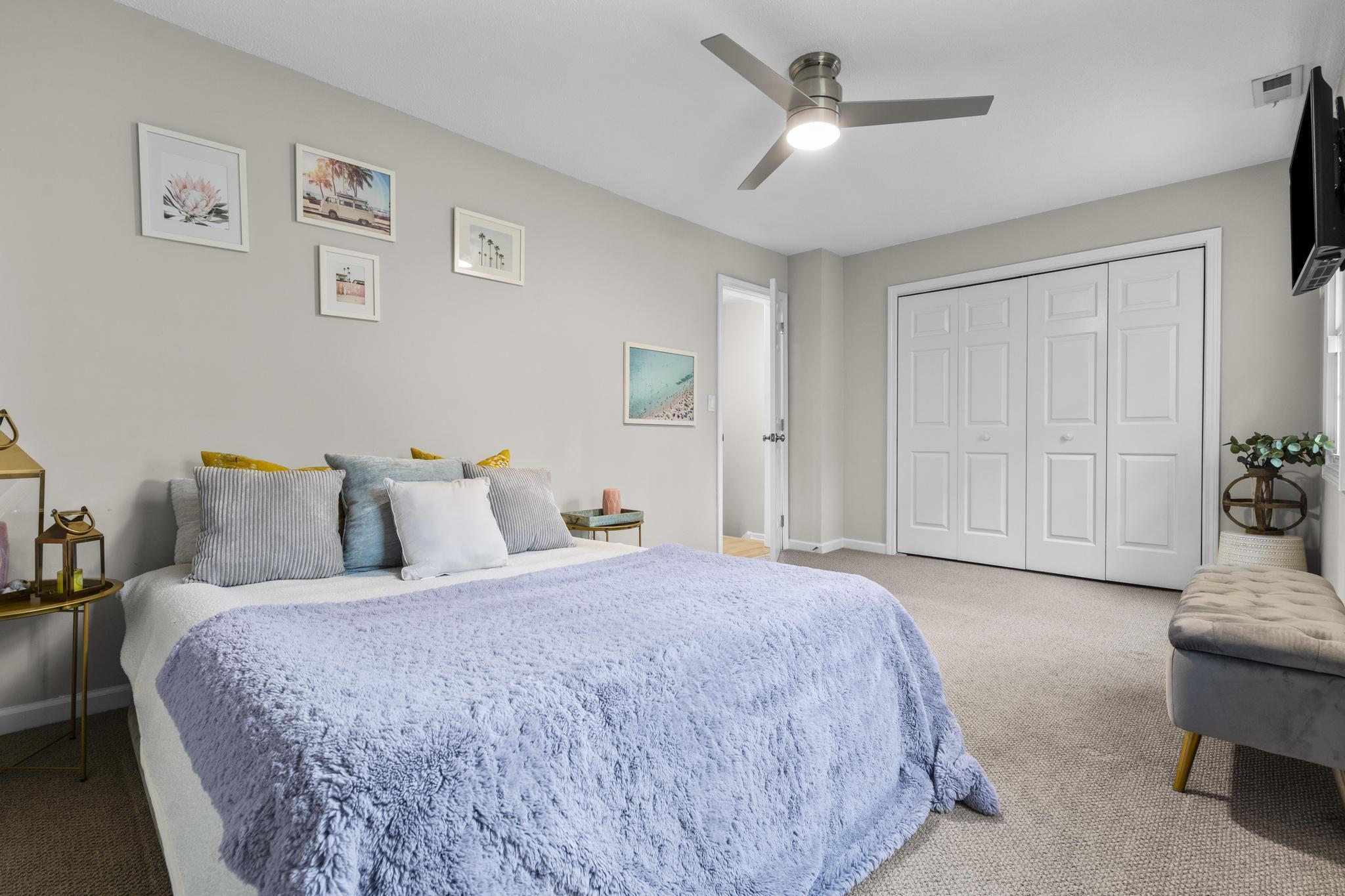 26 Summit Street, Unit 26 Derby, CT 06418 - Photo 27 of 35 a spacious bedroom with a bed and a chandelier