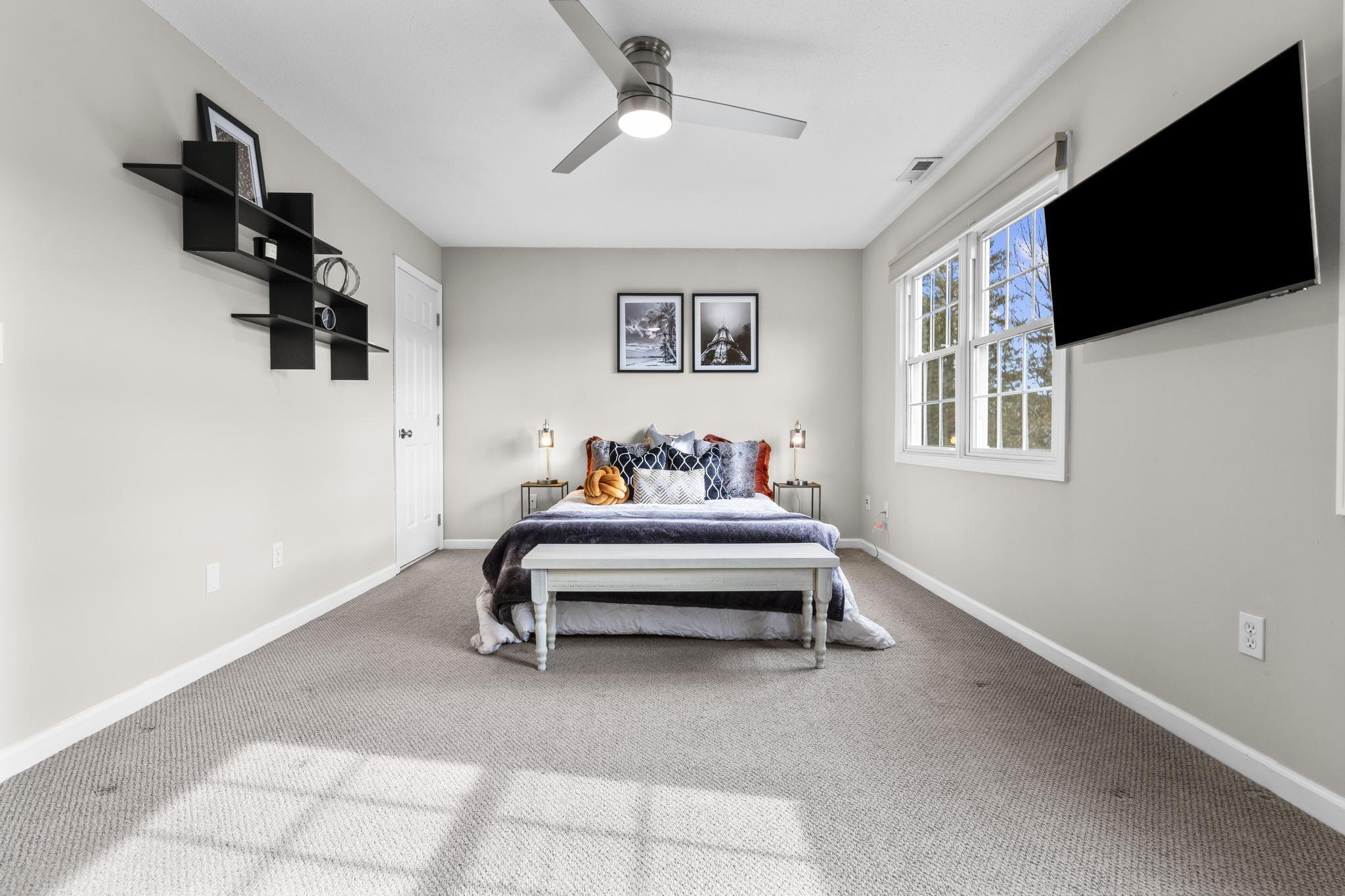 26 Summit Street, Unit 26 Derby, CT 06418 - Photo 28 of 35 a bedroom with furniture and a flat screen tv