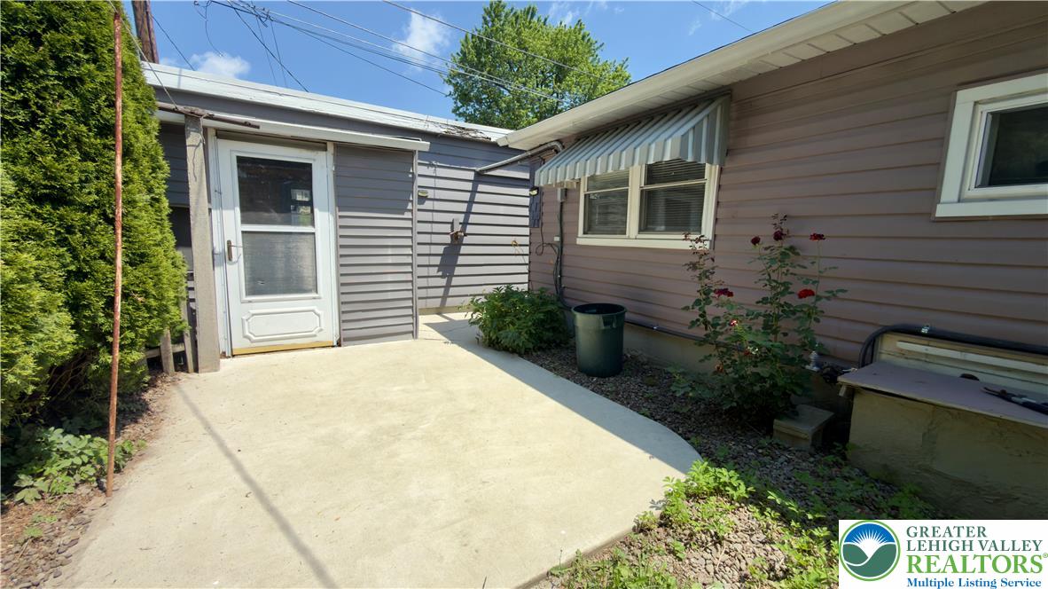 246 Poplar Street Bath, PA 18014 - Photo 6 of 34 A well-maintained side yard with a concrete patio offers a private outdoor space.