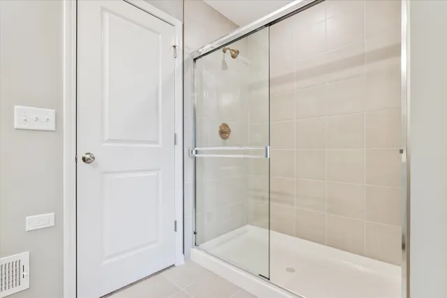 a bathroom with a glass shower door