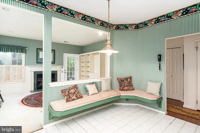 a spacious bedroom with furniture and a large window