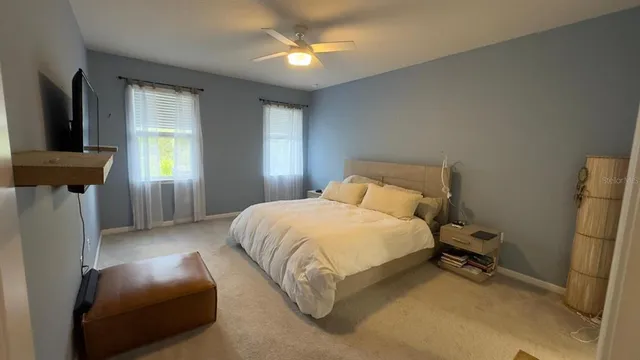 a bedroom with a bed and a chandelier