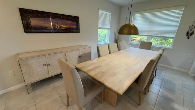 a dining room with furniture and window