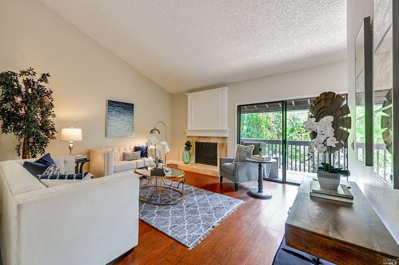 344 Los Alamos Road, Unit 26 Santa Rosa, CA 95409 - Photo 1 of 1 a living room with furniture fireplace and a large window