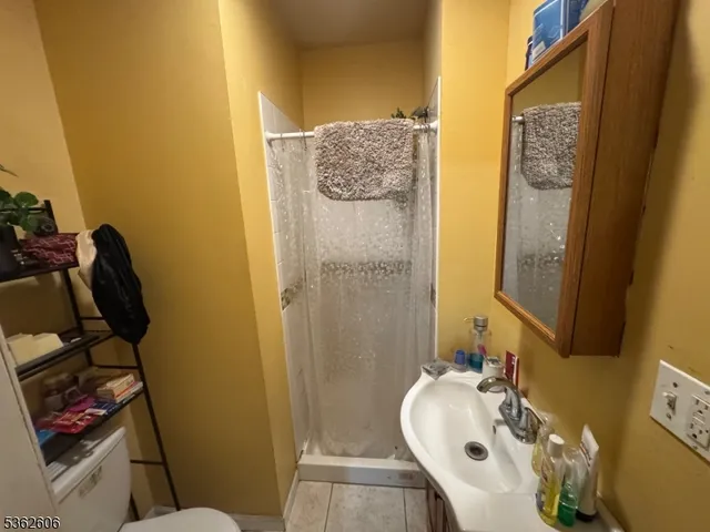 a bathroom with a sink and mirror with toilet
