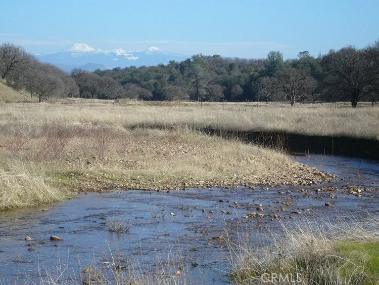 a view of dirt road with a beach