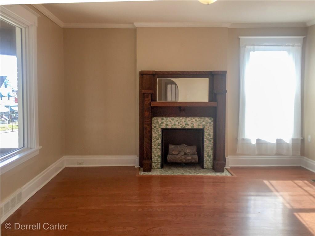 452 Ohio Avenue Rochester, PA 15074 - Photo 5 of 17 Living room with a large picture window for plenty of light hardwood floors and a beautiful mantel.