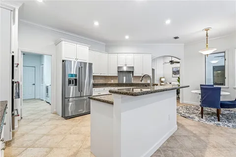 a kitchen with refrigerator and cabinets
