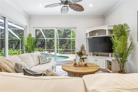 a living room with fireplace furniture and a large window