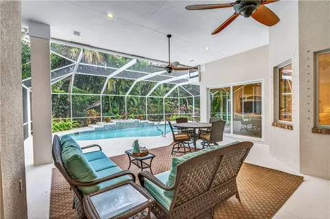 a dining room with furniture and floor to ceiling window