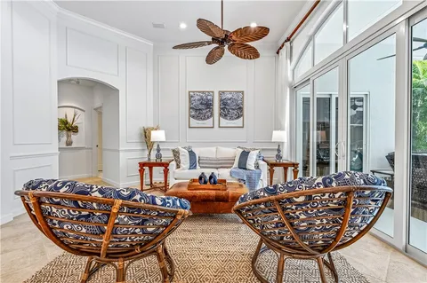 a living room with furniture a rug and a chandelier