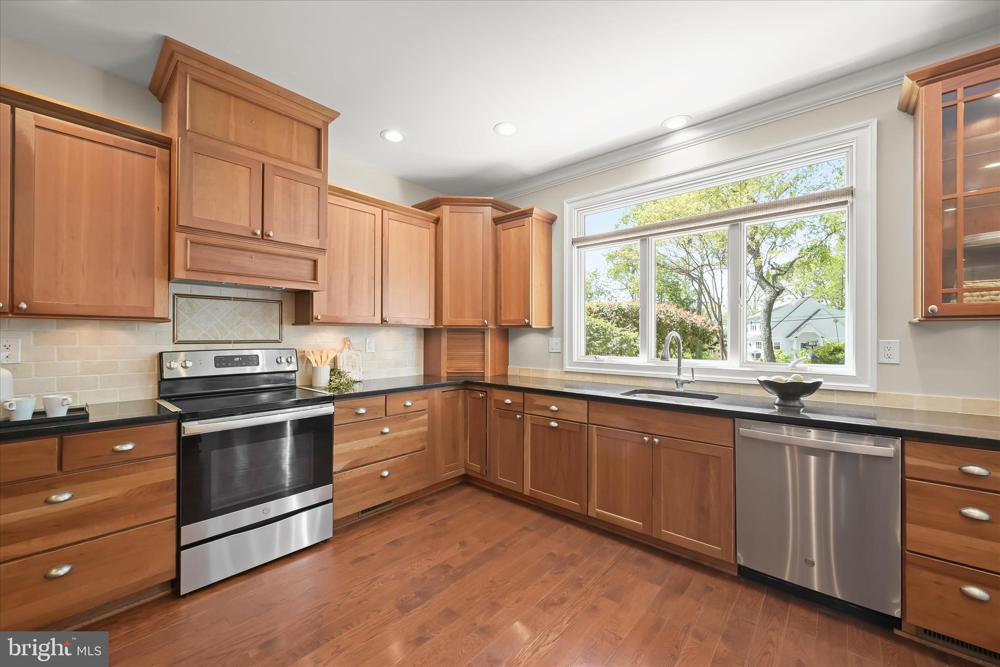 620 Jumpers Hole Road Severna Park, MD 21146 - Photo 24 of 112 a kitchen with granite countertop wooden cabinets stainless steel appliances a sink and a window