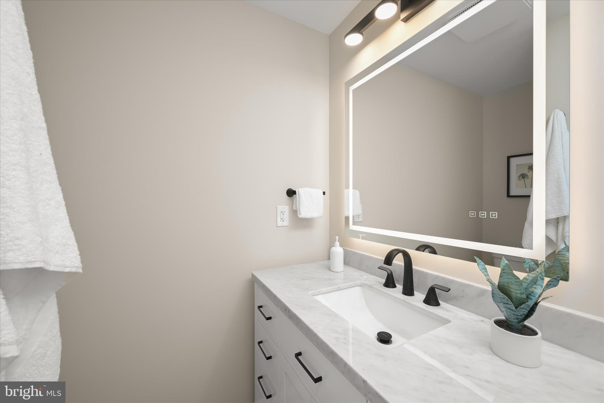 620 Jumpers Hole Road Severna Park, MD 21146 - Photo 65 of 112 a bathroom with a sink and a mirror