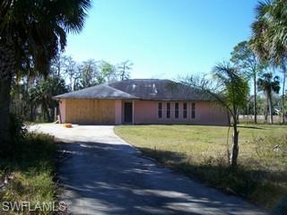 360 16th Avenue Northwest Naples, FL 34120 - Photo 1 of 6 a view of a house with a yard