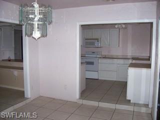 360 16th Avenue Northwest Naples, FL 34120 - Photo 3 of 6 a kitchen with white cabinets and counter space