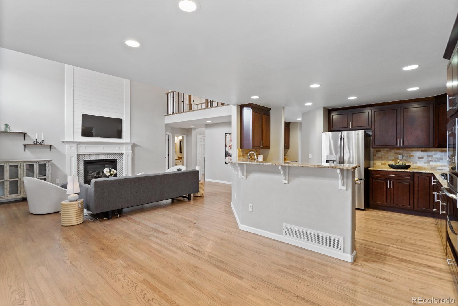 6681 Secrest Circle Arvada, CO 80007 - Photo 12 of 50 a living room with furniture and a fireplace