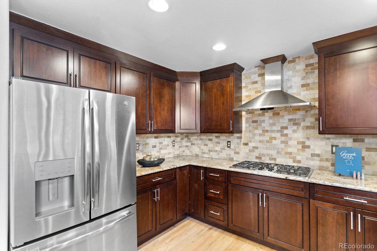 6681 Secrest Circle Arvada, CO 80007 - Photo 14 of 50 a kitchen with stainless steel appliances granite countertop a refrigerator and a sink