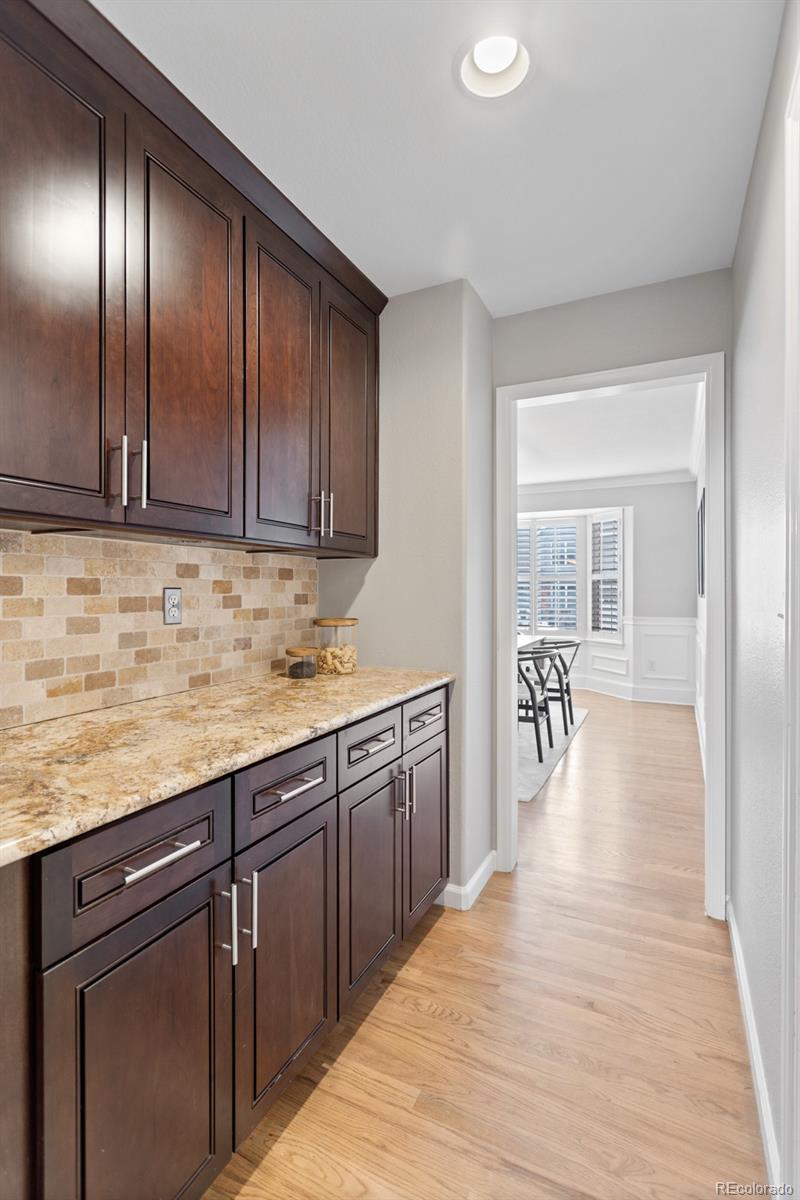 6681 Secrest Circle Arvada, CO 80007 - Photo 20 of 50 a kitchen with granite countertop a sink and cabinets