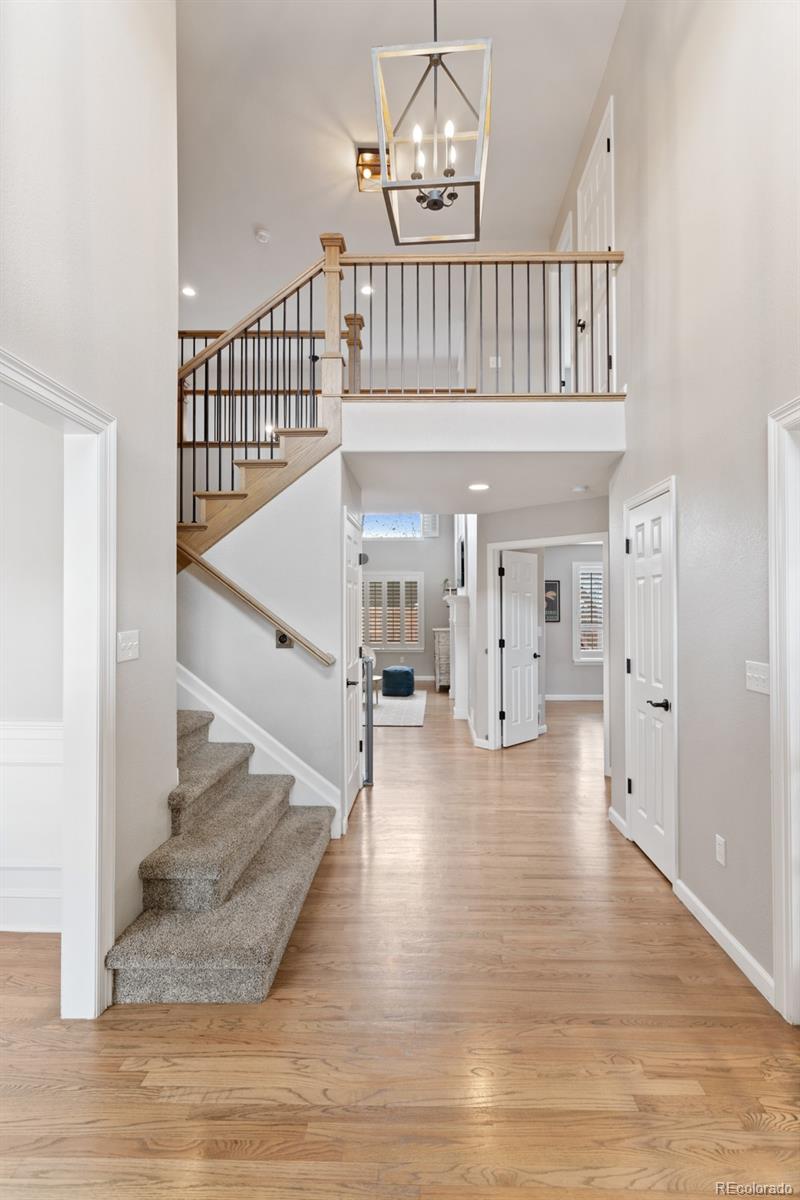 6681 Secrest Circle Arvada, CO 80007 - Photo 2 of 50 a view of entryway and hall with wooden floor