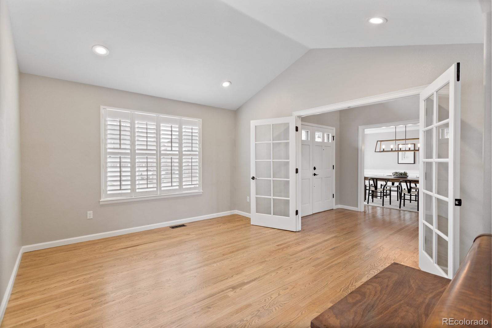 6681 Secrest Circle Arvada, CO 80007 - Photo 23 of 50 a view of an empty room with wooden floor and a window