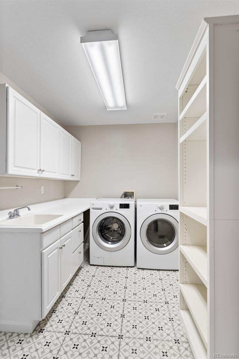 6681 Secrest Circle Arvada, CO 80007 - Photo 28 of 50 a utility room with sink dryer and washer