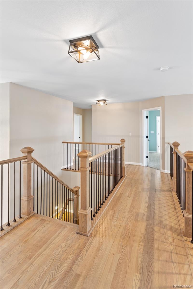 6681 Secrest Circle Arvada, CO 80007 - Photo 30 of 50 a view of a bedroom with wooden floor