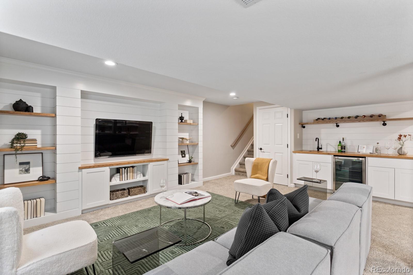 6681 Secrest Circle Arvada, CO 80007 - Photo 40 of 50 a living room with furniture and a flat screen tv
