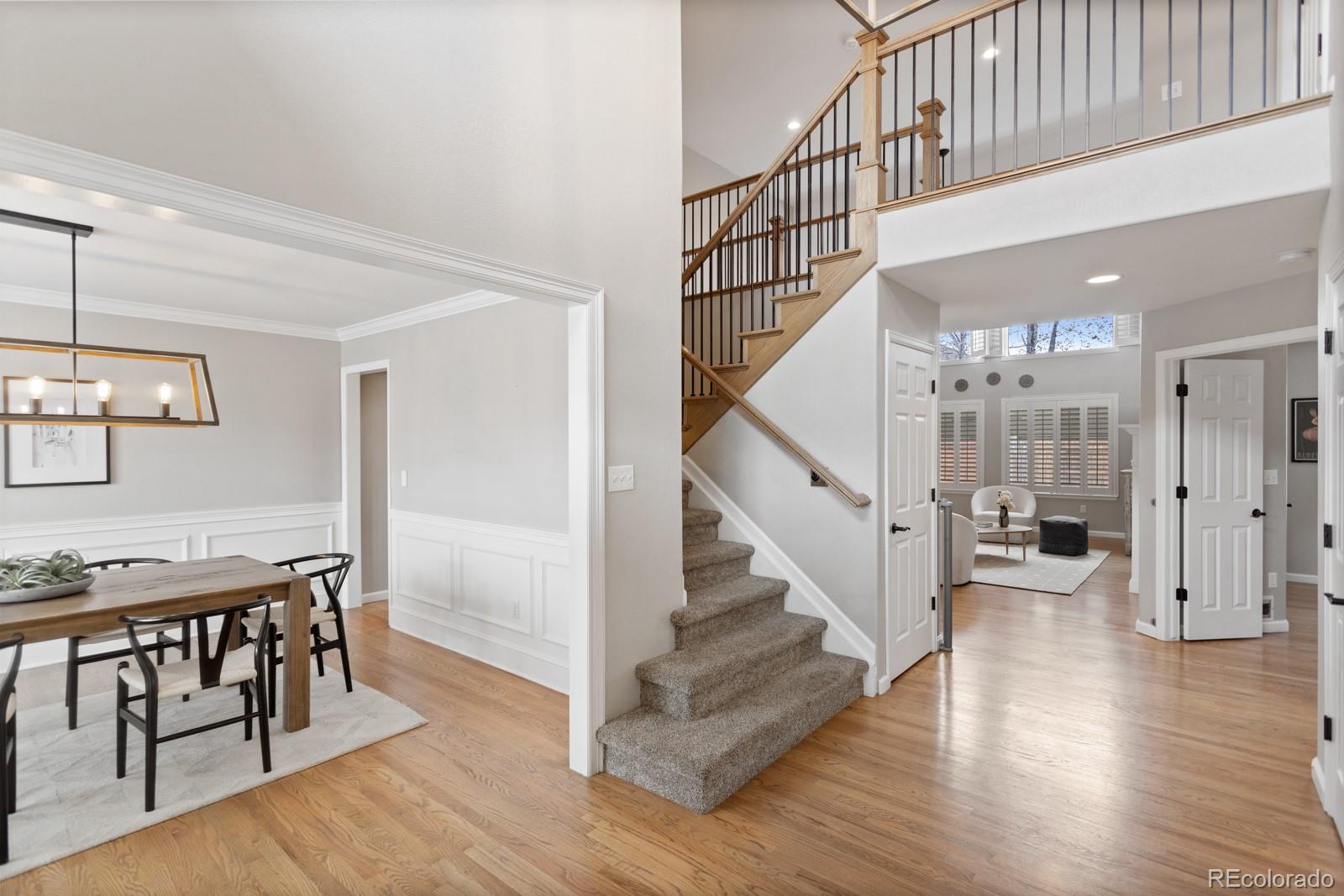 6681 Secrest Circle Arvada, CO 80007 - Photo 7 of 50 a view of entryway and hall with wooden floor