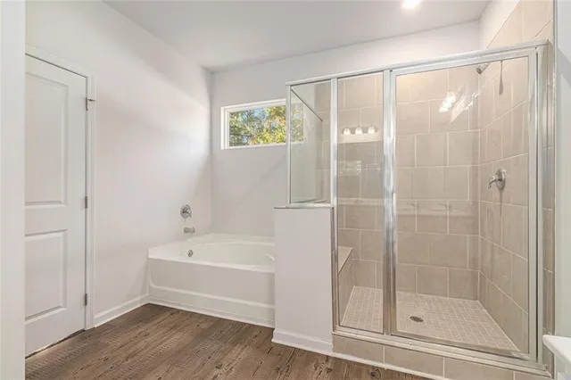 a bathroom with a bathtub and a shower