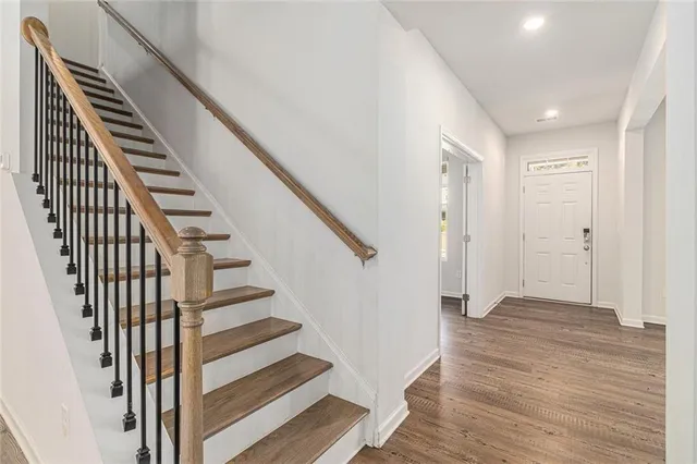 a view of a hallway with wooden floor and entryway