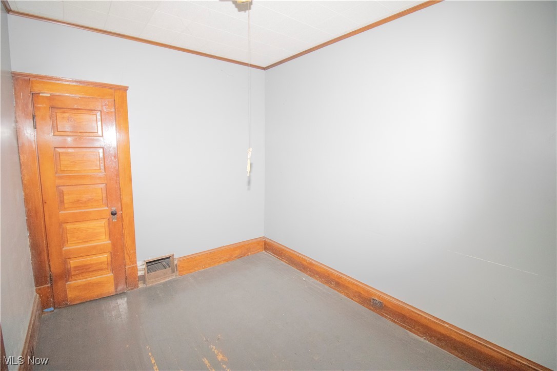 3486 Kimmel Road Cleveland, OH 44105 - Photo 4 of 12 Empty room featuring ornamental molding and concrete floors
