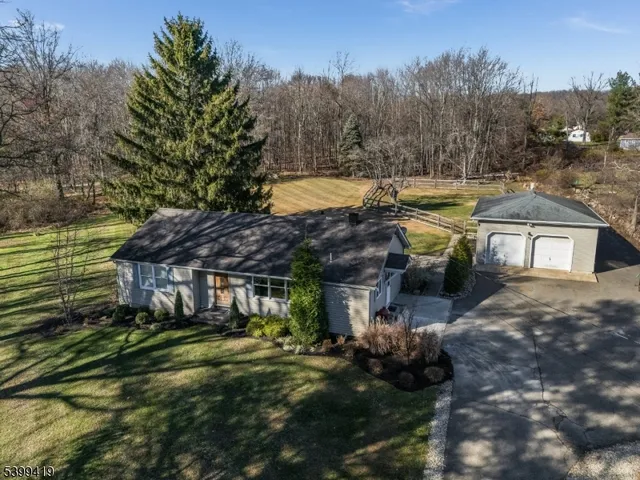 a view of a house with a yard patio and fire pit