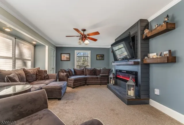 a living room with furniture a fireplace and a large window