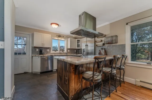 a kitchen with a table chairs refrigerator and cabinets