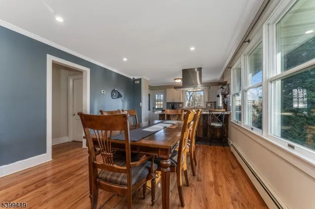 a dining room with furniture and wooden floor