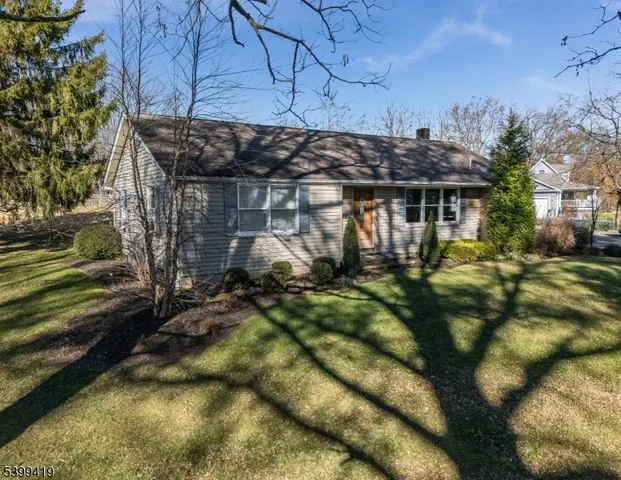 an aerial view of residential house and grassy field