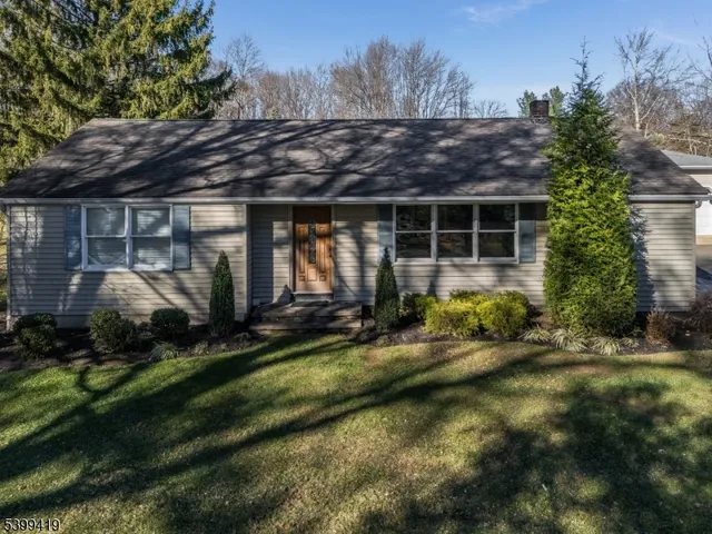 a view of a house with swimming pool and sitting area