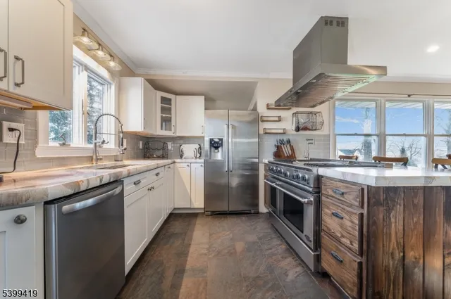 a kitchen with stainless steel appliances granite countertop a stove and a sink