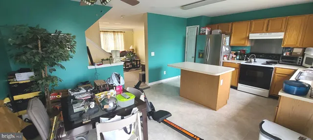 a living room filled with furniture and a wooden floor