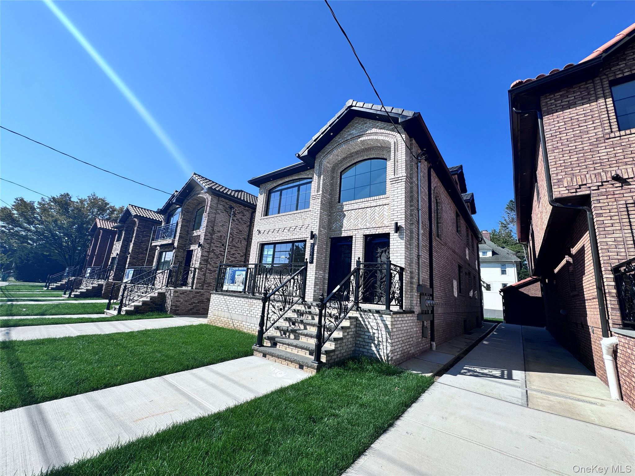 View of front of house featuring a front lawn and brick siding