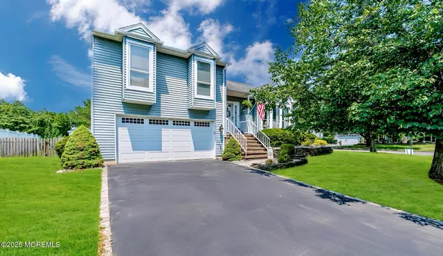 a view of a house with a yard and sitting area