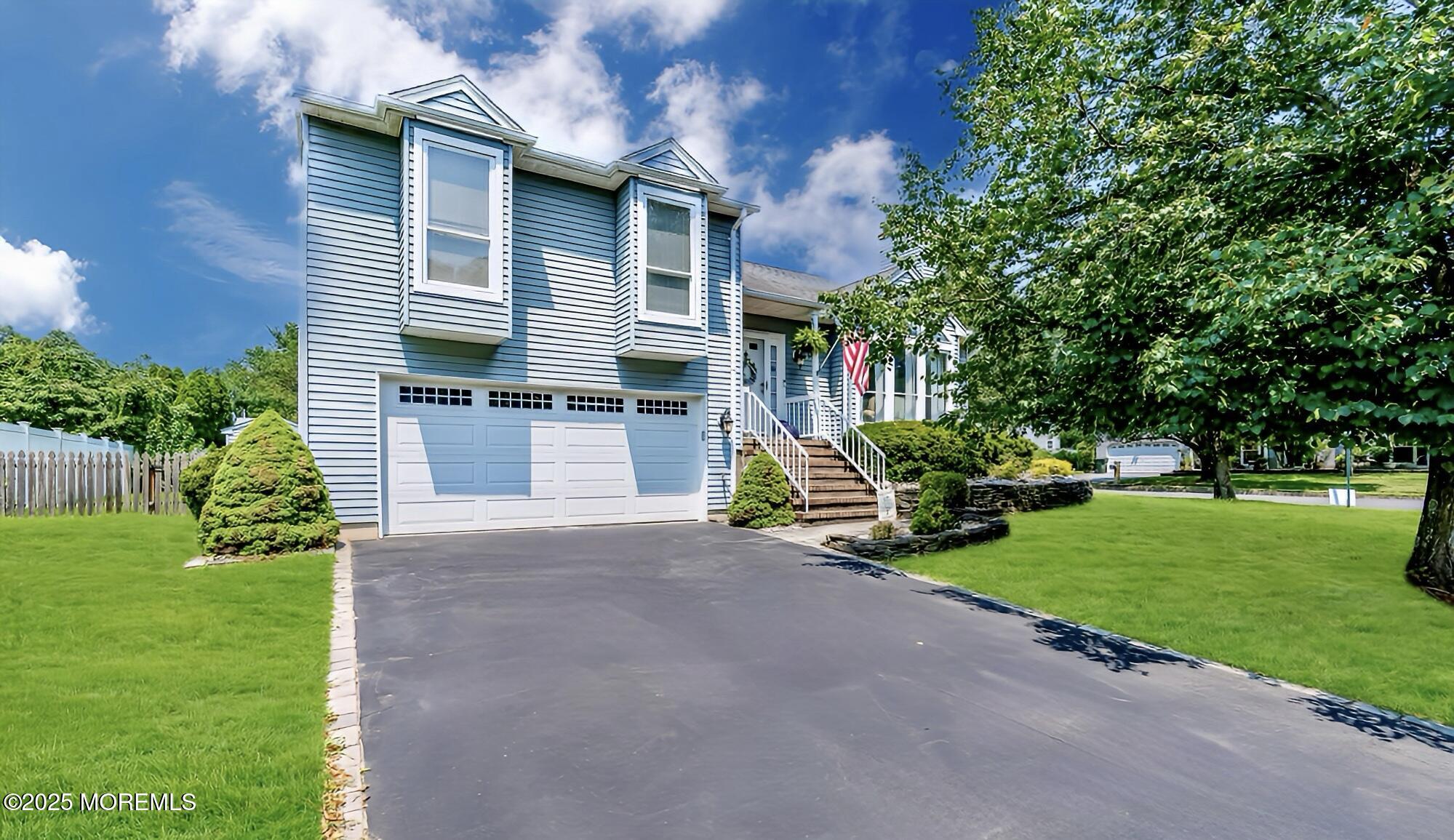 a view of a house with a yard and sitting area