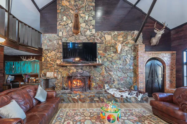 a kitchen with stainless steel appliances granite countertop a sink a stove and a wooden cabinets