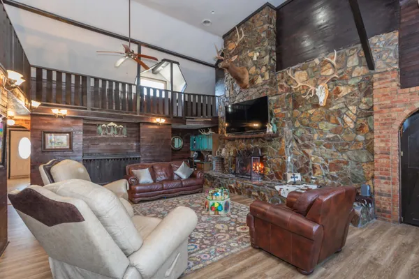 a living room with furniture a wooden floor and a fireplace