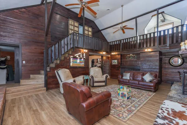 a living room with furniture fireplace and a large window