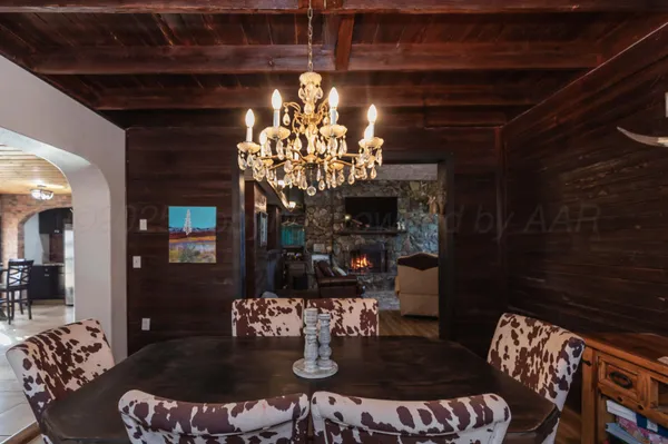 a bedroom with a bed and a table in it with wooden floor