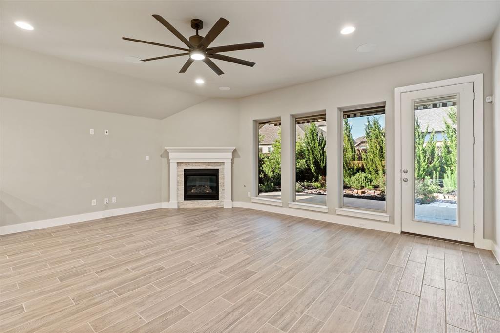 1314 Buttermere Street Forney, TX 75126 - Photo 4 of 32 a view of an empty room with wooden floor and a window