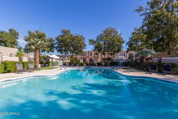 a swimming pool view with a outdoor seating