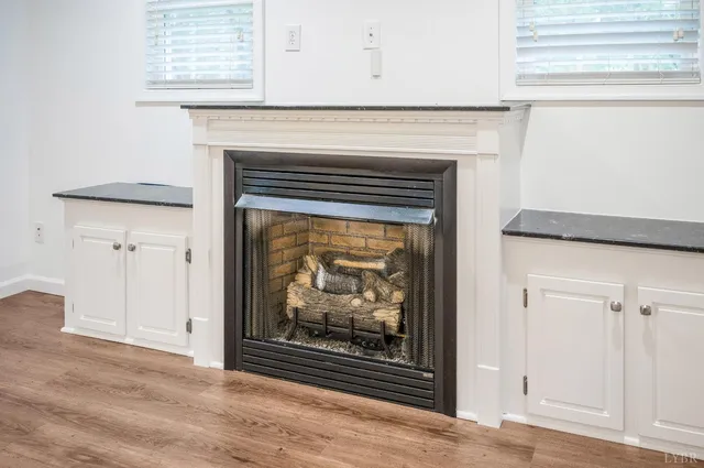 a view of fireplace with wooden floor